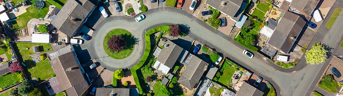 Aerial view of suburban estate with large houses and gardens 